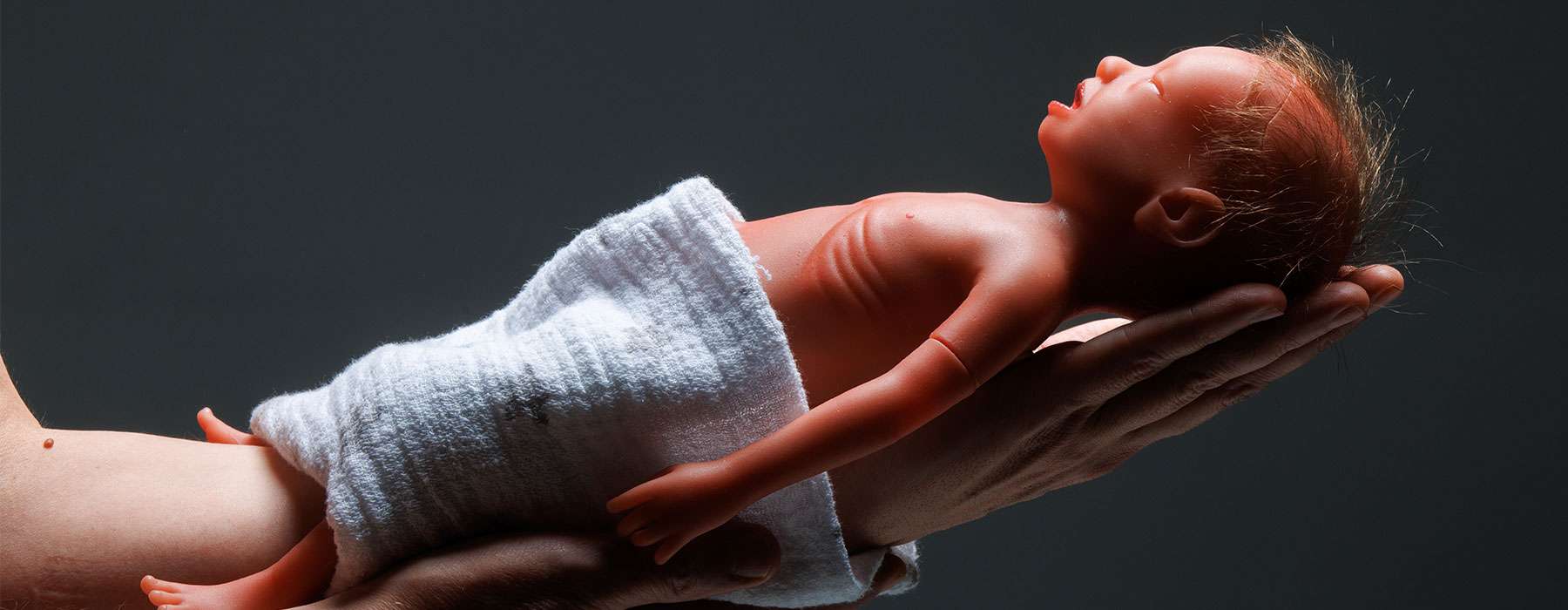 Paul being held by midwife