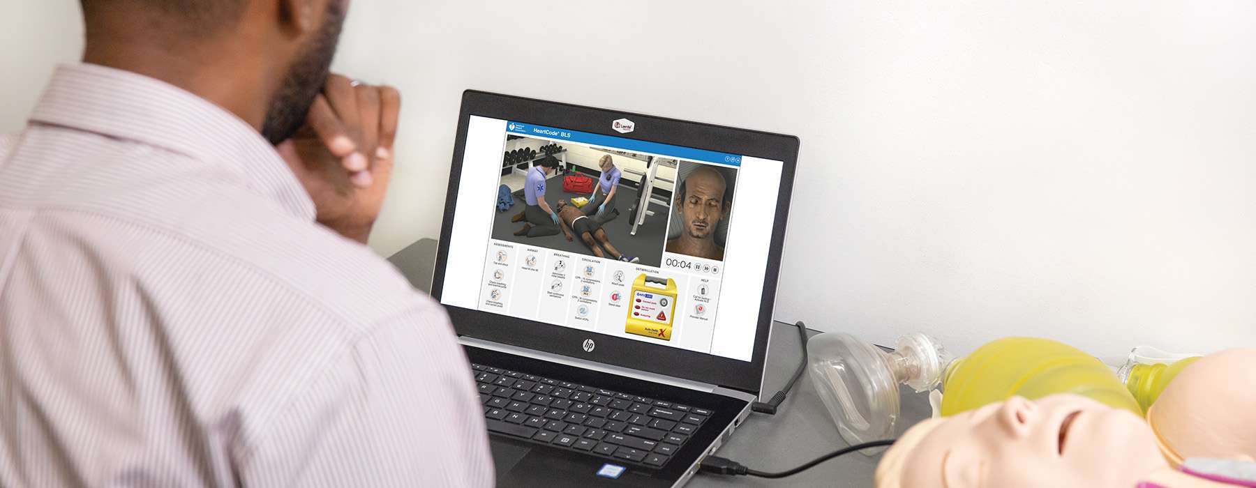 A student reviewing a digital resuscitation case study on a laptop, showing a 3D simulated environment and clinical assessment tools.