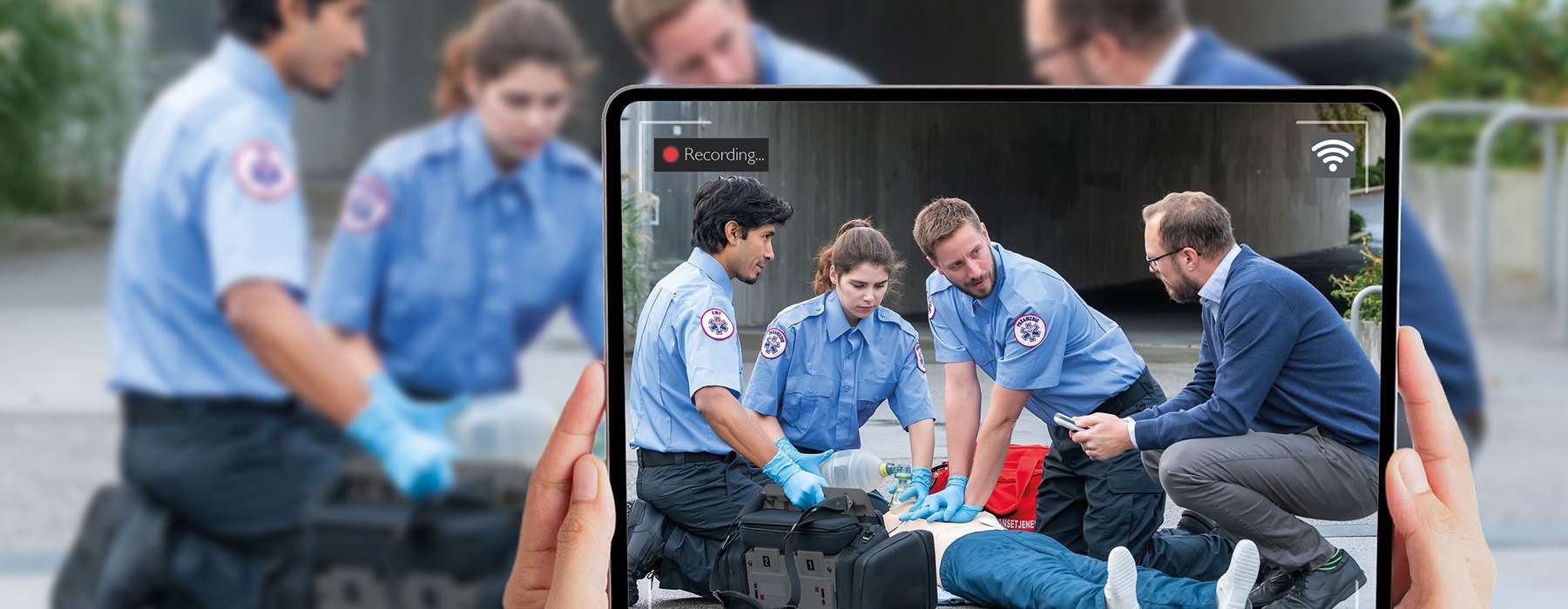 A tablet screen capturing a team of EMS providers and an instructor during an outdoor simulation to facilitate real-time performance feedback.