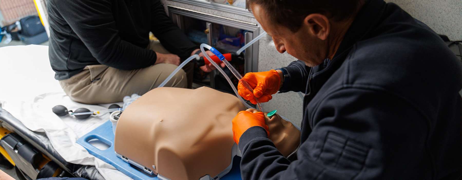 Two healthcare providers collaborating on advanced airway management during a simulation session.