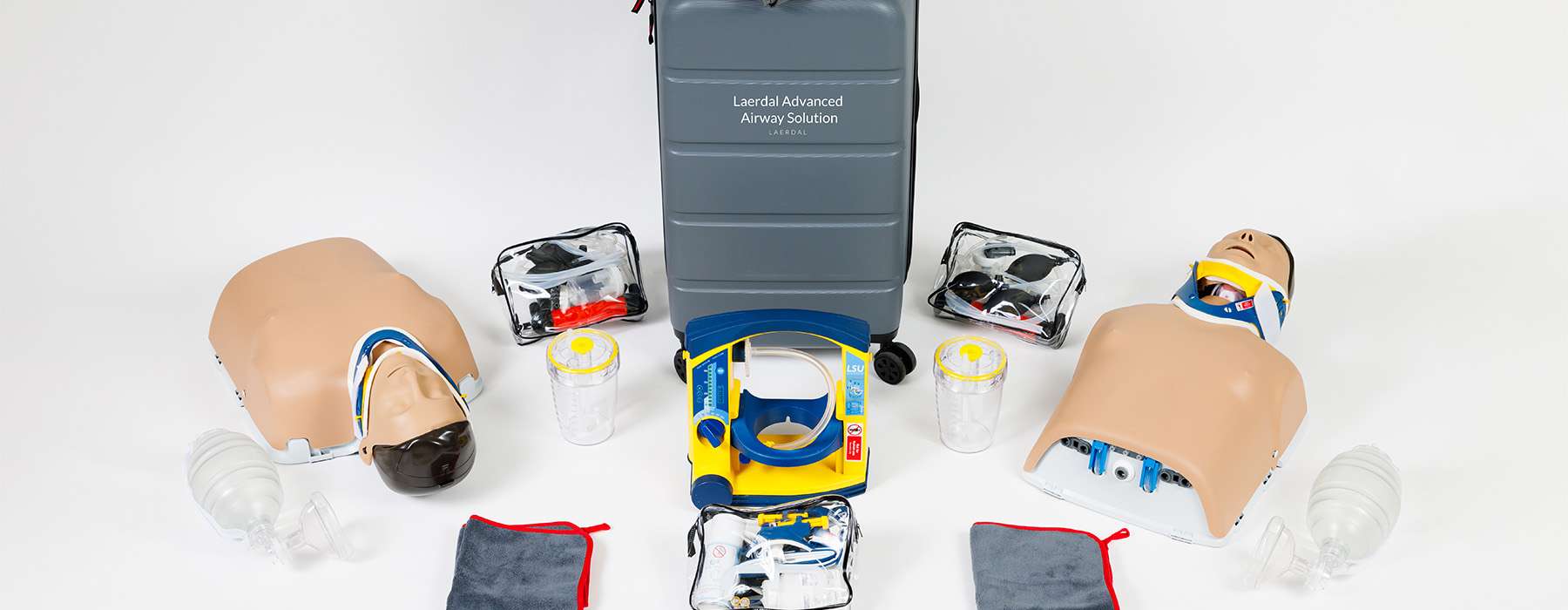 A product shot of the Laerdal Advanced Airway Solution, including simulators, suction units, and various clinical accessories for training.