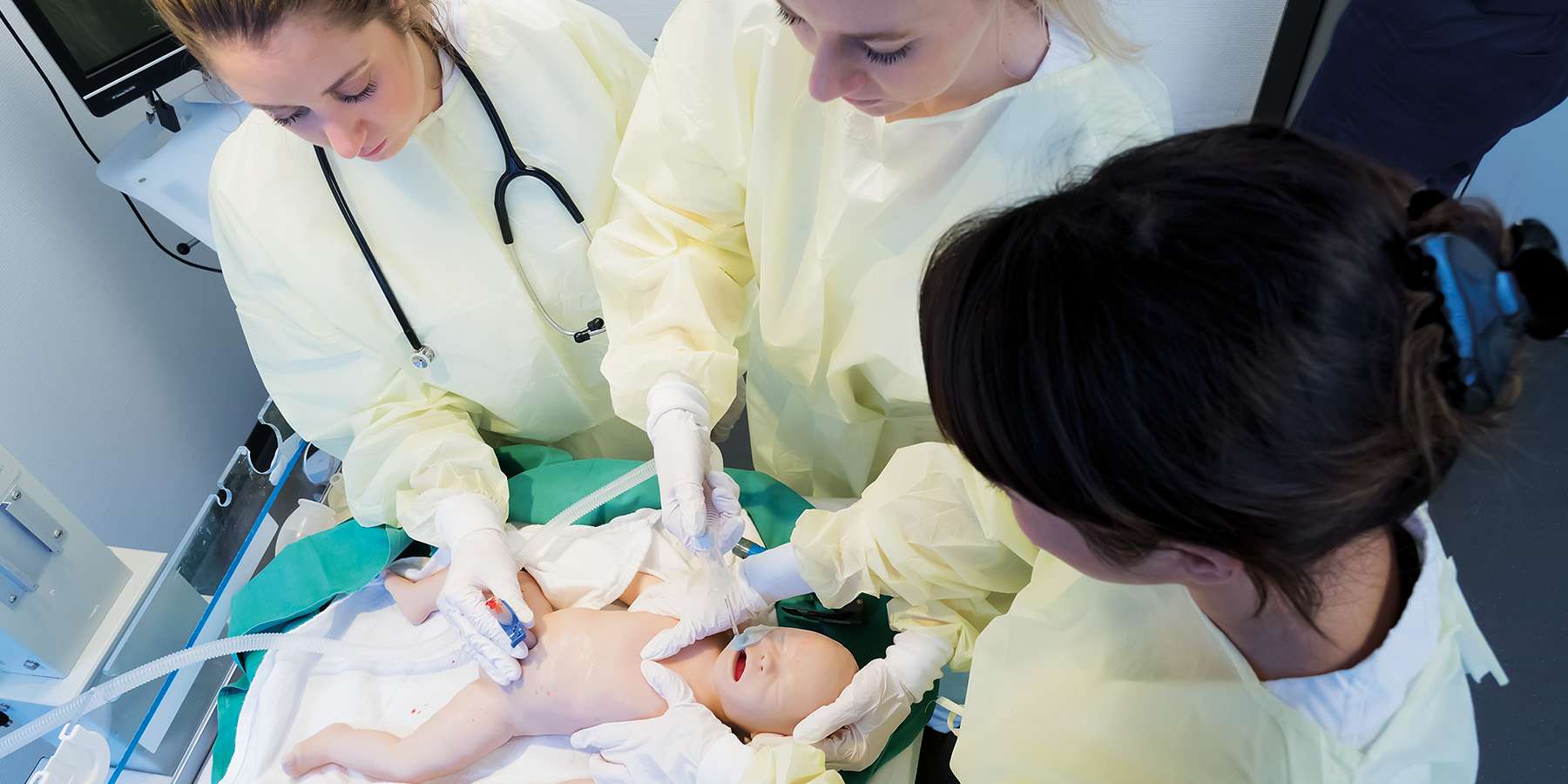 Three nursing students using SIMCharacters Paul to practice
