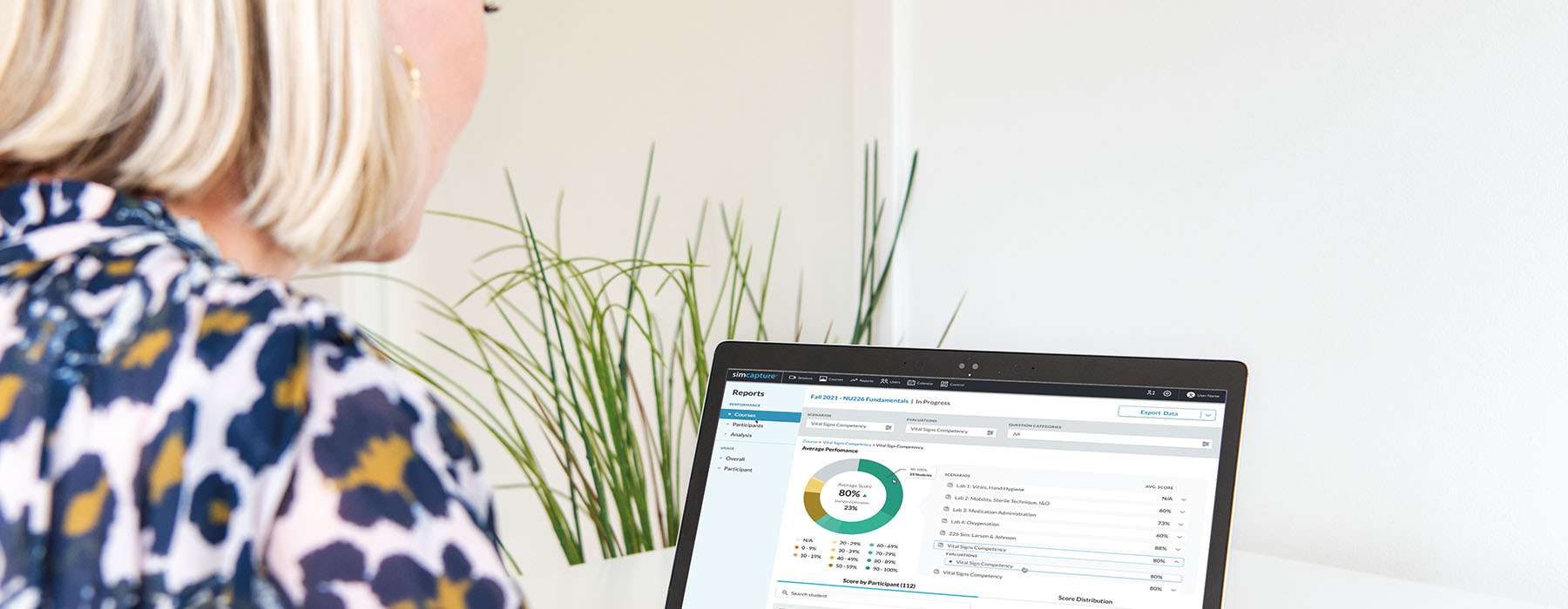 Review of competency reports and score distributions on a laptop