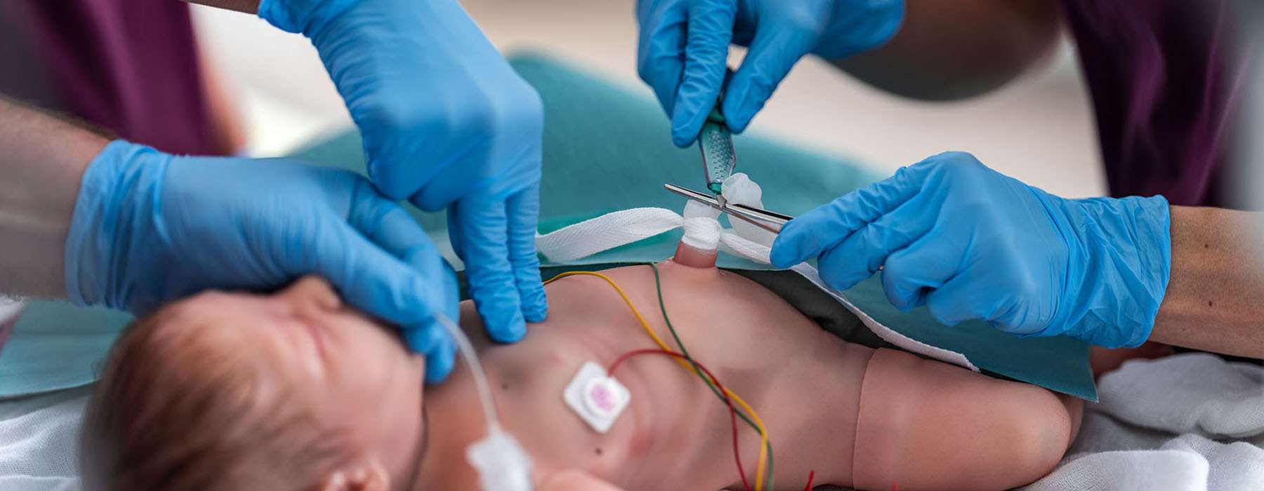 a closeup from  NICU. Glowed hands working on a newborn baby.