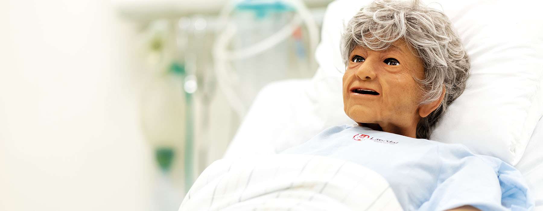 Nursing Anne Simulator geriatric on a bed