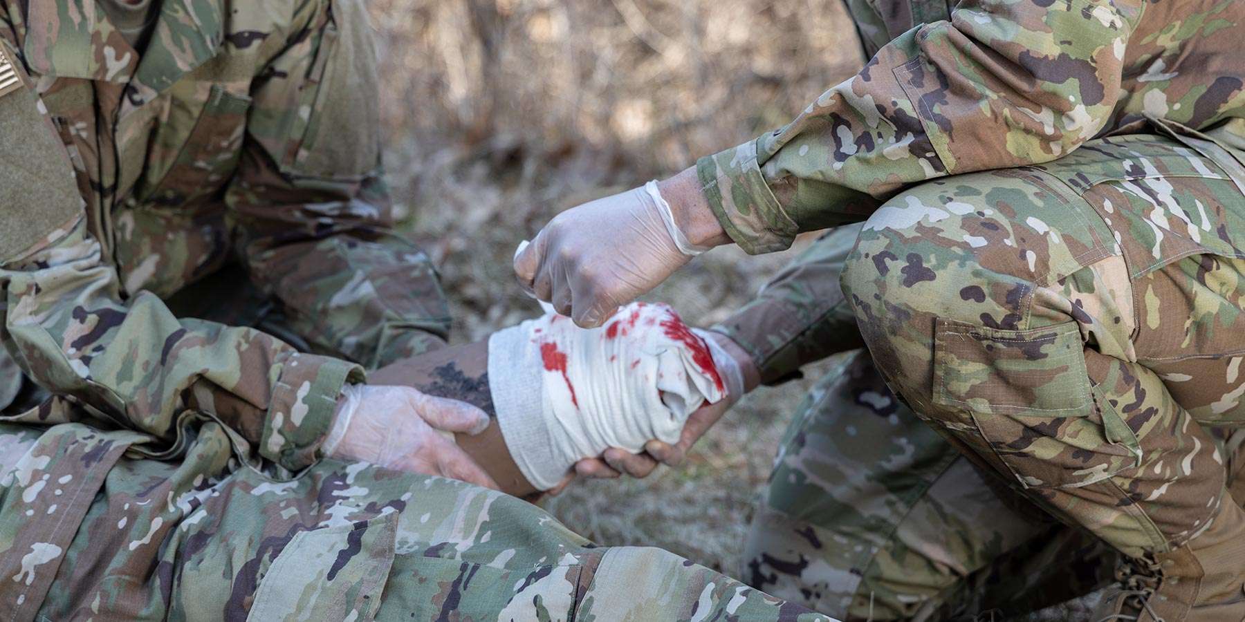 Military attending a wound on SimMan 3G