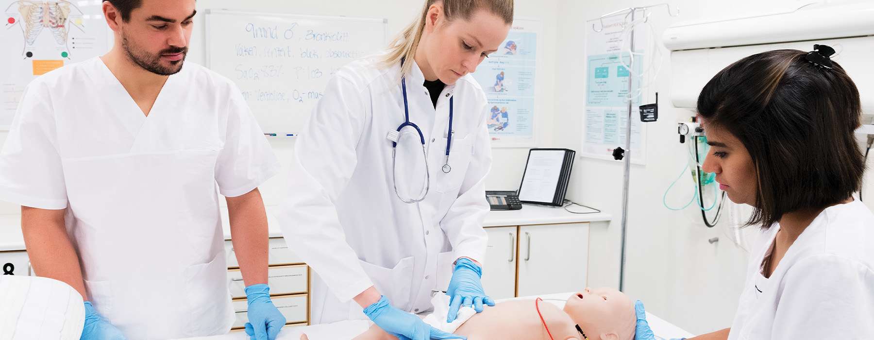 Three nurses practicing simulation training on SimBaby.