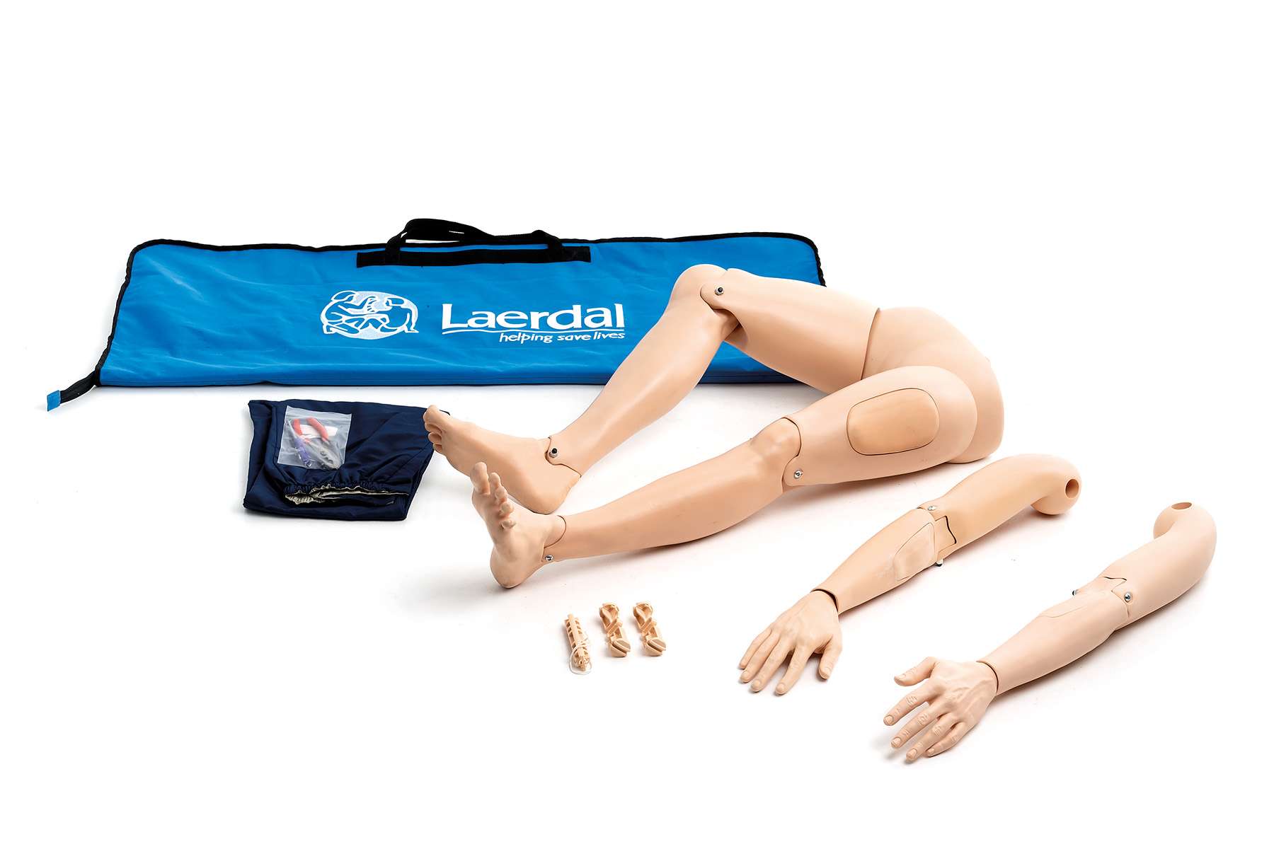 A product shot displaying interchangeable limbs (legs and arms) for a manikin, along with a blue carrying bag and training accessories on a white background.