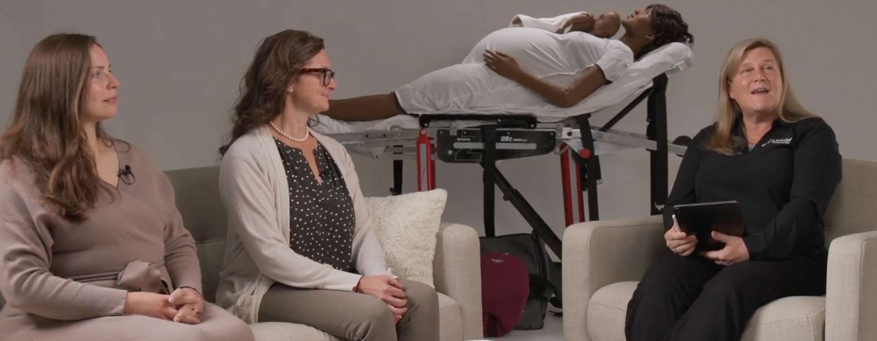 Three professionals in a studio setting participating in a panel discussion.