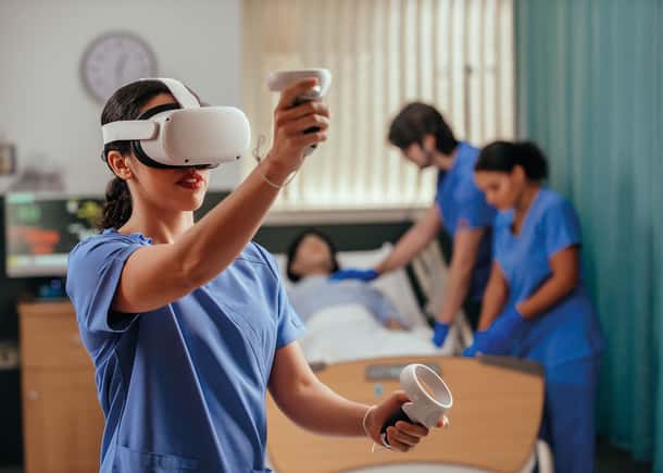 nursing student using vrClinicals in front of other students that are blurred in the background. 